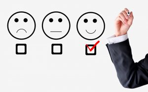 Customer satisfaction concept with businessman hand drawing smil
