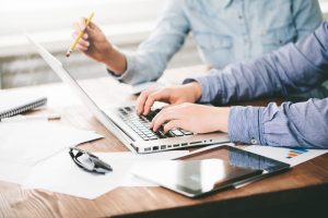 two people looking at laptop